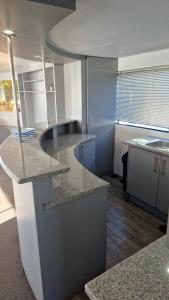 a kitchen with granite counter tops in a room at Old Willow Houseboats in Sasolburg +46 photos
