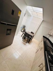 a kitchen and dining room with a table and chairs at Aluna Hotel, Laureles Medellín in Medellín +3 photos