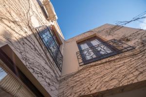 a building with two windows on the side of it at Nuevos Horizontes in Tandil