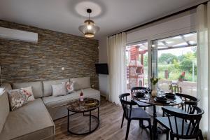 a living room with a couch and a table at En Sophia Guesthouse in Maronia