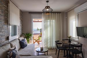 a living room with a couch and a table at En Sophia Guesthouse in Maronia