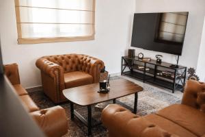 a living room with two chairs and a tv at Casa ZOMABRIA in Poreč