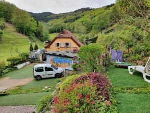 a white car parked in front of a house at Tiny House cosy, jardin romantique forestier, route du vin, sentiers in Lalaye