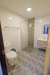 a bathroom with a toilet and a shower and a sink at พฤกษา วัลเลย์ รีสอร์ท in Ban Mak +27 photos