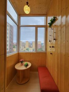 a small room with a table and a window at Ulaanbaatar Sky Residence in Ulaanbaatar