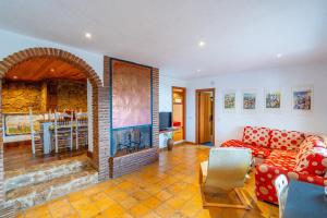 a living room with a couch and a fireplace at Cubo's Villa La Gitanilla in Mijas +55 photos