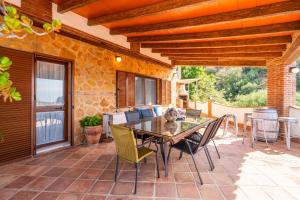 a patio with a glass table and chairs at Cubo's Villa La Gitanilla in Mijas