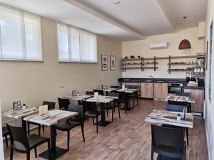a restaurant with tables and chairs in a room at Le Métro in Carini +41 photos