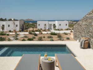 a villa with a swimming pool and a resort at Ovea Paros in Naousa