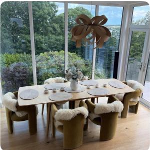 a dining room table and chairs with a large window at Mincarlo House in St Austell