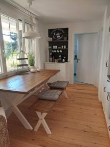 a dining room with a wooden table and chairs at Filipponi's Träumli in Rüthi