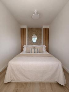 a bedroom with a large bed with a white bedspread at Cala Crancs - Sea Views in Salou +8 photos