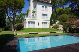 a house with a swimming pool in front of a house at Villa Cœur de Mer in Nice