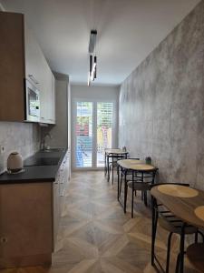 a kitchen with tables and chairs and a counter at Aria venice rooms in Tessera