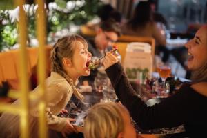 a group of people sitting around a table eating food at Resort Mooi Bemelen in Bemelen