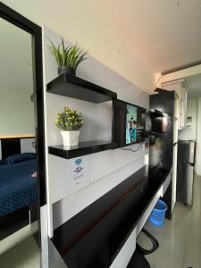 a room with a reception desk with flowers on it at Vinsroom Dua at Green Park in Seturan