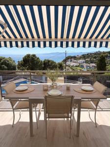 a dining table with chairs and a view of the ocean at Cala Crancs - Sea Views in Salou