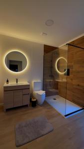 a bathroom with a toilet and a sink and a shower at Francisca Apartment in Lajes +6 photos