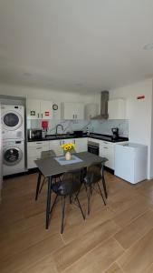 a kitchen with a table and two chairs in it at Francisca Apartment in Lajes