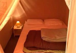 a small room with two beds in a tent at Camping 3 étoiles - Piscine - ccbfhii in Bouzic