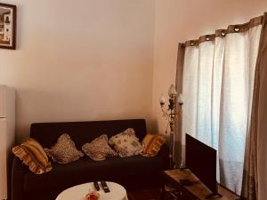 a living room with a couch with pillows on it at Mãe Home Carril in Caldas da Rainha