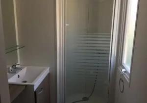 a bathroom with a glass shower and a sink at Camping 3 étoiles - Piscine - ccbfhii in Bouzic