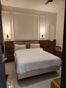 a bedroom with a large white bed with two pillows at Hotel Manchester Royals LLP in Boria Kalān +41 photos