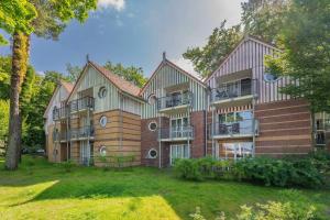 a large building with balconies on the side of it at Ferienanlage Seeblick Aquamarin in Koserow