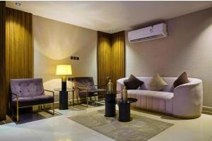 a living room with a couch and two chairs at Nawara Dala - Economic in Riyadh