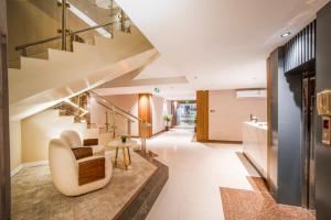 a living room with a staircase and a chair at Nawara Dala - Economic in Riyadh