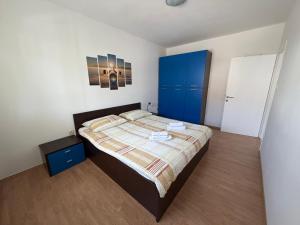 a bedroom with a bed and a blue cabinet at More Space, More Memories -Lana Rab Apartment in Rab