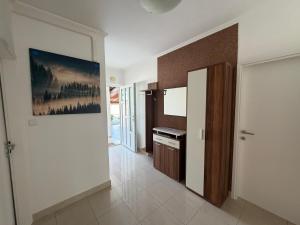 a kitchen with a painting on the wall at More Space, More Memories -Lana Rab Apartment in Rab