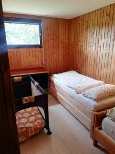 a small bedroom with a bed and a window at Alb-Refugium - beautiful, quiet in Schopfloch
