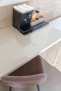 a printer sitting on top of a white desk with a chair at Vulcanica By Dimorra in Pozzuoli +61 photos