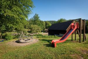 a playground with a red slide in a park at Haus zur Mühle in Winterberg