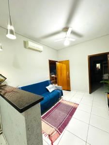 a living room with a blue couch in a room at Rancho Camiotto in Rubinéia +31 photos