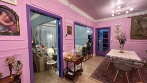 a pink room with a table and a couch at House Of Lith in Punta Arenas +69 photos