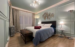 a bedroom with a bed with a red bag on it at House Of Lith in Punta Arenas