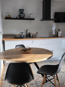 a kitchen with a wooden table and two chairs at A Casinha - By Marketignite in Barreira +5 photos