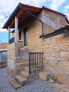 a stone house with a staircase in front of it at A Casinha - By Marketignite in Barreira