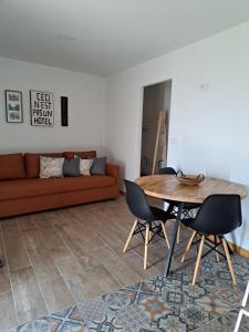 a living room with a table and a couch at A Casinha - By Marketignite in Barreira