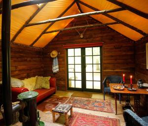 a living room with a red couch in a cabin at Adhurst Yurts in Sheet