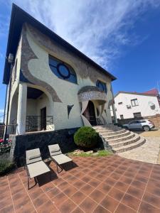 a building with two chairs in front of it at Дом Каролино-Бугаз у моря in Zatoka