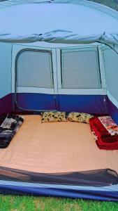 a tent with two pillows on the bed in it at TIS Zipline Campingsite in Gurais