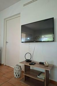 a living room with a large flat screen tv on the wall at Panoráma Vendégház in Sümeg