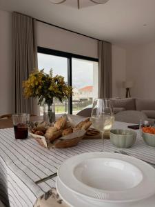 a table with a plate of food and a glass of wine at La Pionera in Mejorada