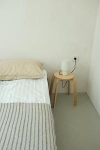 a bedroom with a bed and a table with a lamp at Dadi House Martvili in Martvili