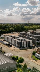 an aerial view of a parking lot with buildings at TheSnoozzze Boardinghouse Winsen - Monteur Apartments in Winsen