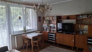 a dining room with a table and a tv at U babiny in Martinske Hole