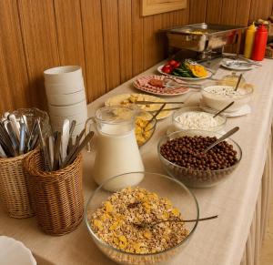 a table topped with bowls of food and milk at Chata Návrší in Stříbrnice +9 photos